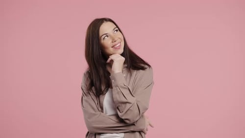 Young Woman Dreaming with Thoughtful Look on Pink Dreamy Eyes Imagining Future Plans or Romantic