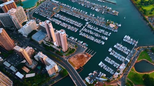 Flight over the road bridge crossing the Ala Wai Canal and large yacht club. Waikiki resort area.