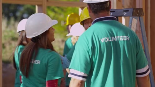 Construction Volunteers Celebrate, Building Together on Sunny Day