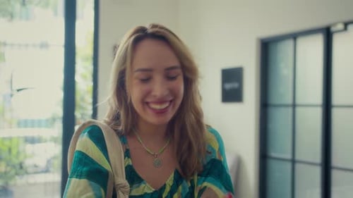 Woman Checking In at Hotel Reception