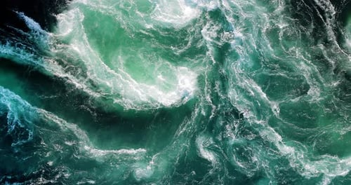 Blue waves of water of the river and the sea meet each other during high tide and low tide.