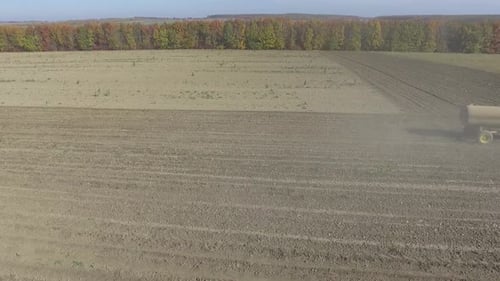 Big red tractor working on the field cultivating and applying nitrogen ASP