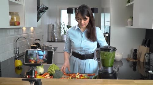 Woman Chopping Vegetables in Kitchen, Recording with Phone
