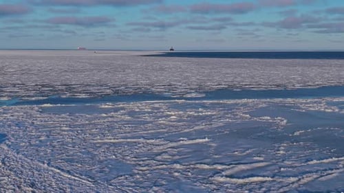 Expansive Cold Seascape with Distant Ridges Remote Aerial Image Showcasing Endless Frozen Sea and