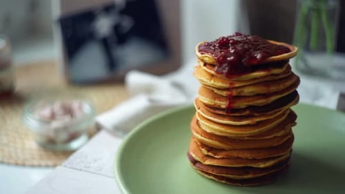 Stack of pancakes with delicious red berry jam