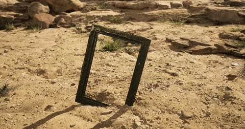 Desert Landscape Featuring an Empty Frame Standing on Sandy Terrain