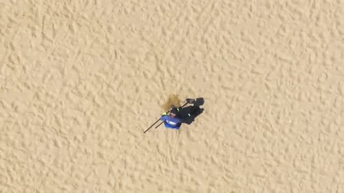 Man with Metal Detector Looking for Precious Objects on Beach of Santa Monica