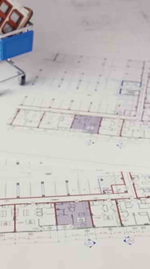 Toy House in Shopping Cart on Architectural Plans