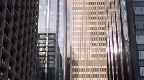 High riser buildings downtown. Sun reflecting from glass windows of business district or skyscraper