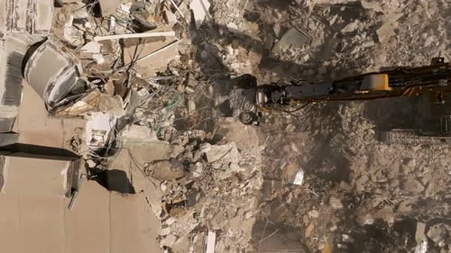 Building demolition excavator using Pulverizer Jaws to demolish a residential building