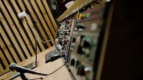 A recording studio control panel mixer with an equalizer faders buttons for broadcasting a recording