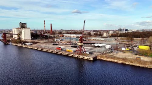 Cranes At The Industrial Port By Daugava River In Andrejsala, Riga, Latvia. - aerial shot