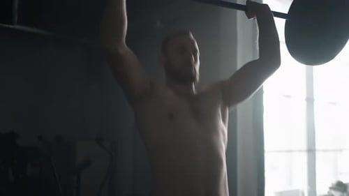 Muscular Bearded Man Lifting Barbell In Gym Active Motion Shot Sport And Fitness Health Club