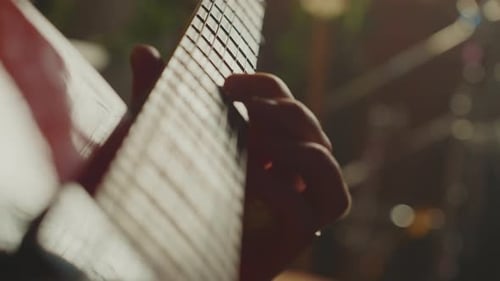 Close Up of Hand Plucking Guitar Strings