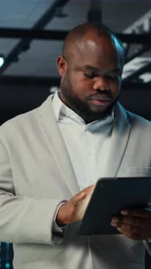 Vertical Video System Administrator Walking in Data Center Analyzing Infrastructure Performance