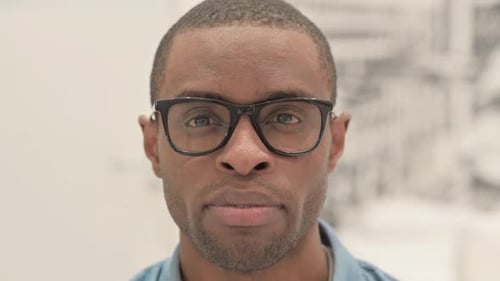 Close Up of Serious African Man Looking at Camera