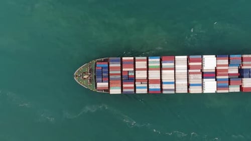 Aerial top view of cargo ship carrying container for import export goods to customer