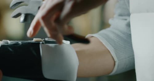 Macro of a shoemaker using a professional machine to bend the shoes and fix them according to the