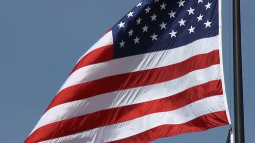 American flag waving proudly in the clear sky