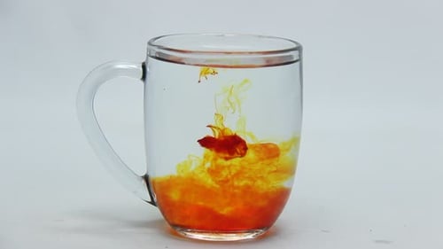 Colorful Liquid Mixing in Glass Mug Close Up