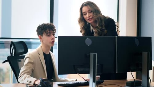 Two Colleagues Working Together in a Modern Office