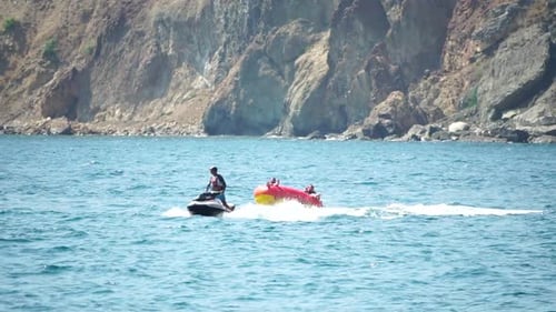 Jet Ski Tows Raft of Friends on Ocean