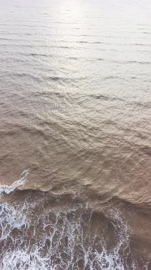 Waves crash on the shore in Tra Vinh, Vietnam, in the morning.