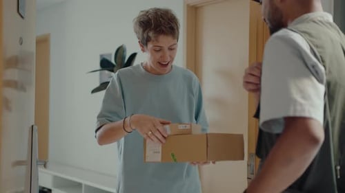 Woman Receives Package from Delivery Man at Door