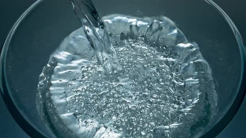 Sparkling Aqua Pouring Glass Top View Closeup