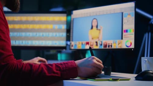 Designer Edits Photo with Pen and Tablet at Desk