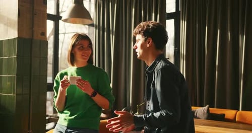 Young Couple Enjoying Coffee and Conversation in Stylish Cafe