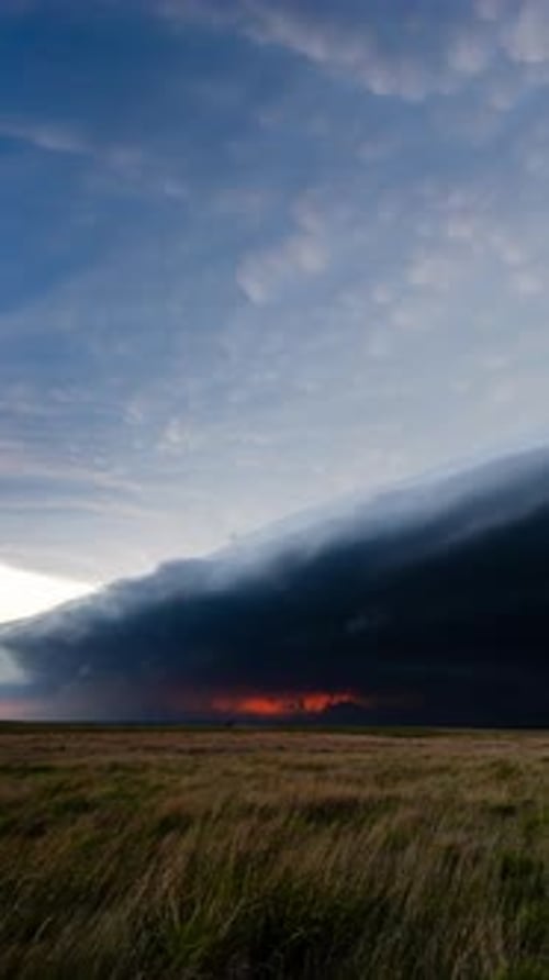 Dramatic Storm Clouds over Open Grassy Field Landscape