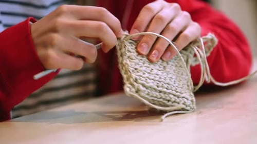 Hands Crocheting Handmade Sponge With Crochet Hook - close up