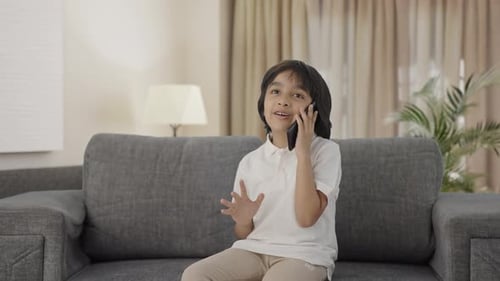 Smiling Child Talking on Smartphone Indoors