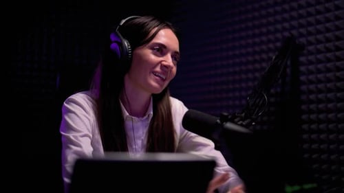 Woman Talking Into Microphone with Headphones On