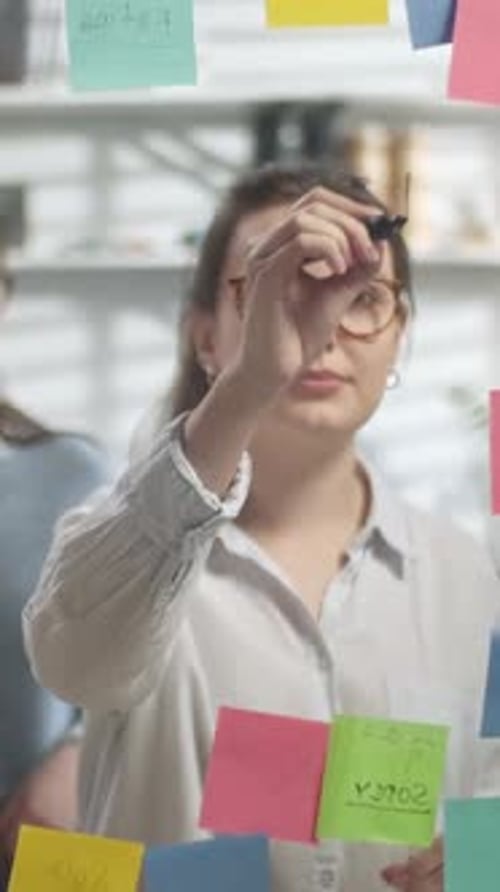 Creative Team Brainstorming Together Using Sticky Notes