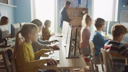 Elementary School Computer Science Classroom: Teacher Uses Tablet Computer, Explains Lesson to Dive