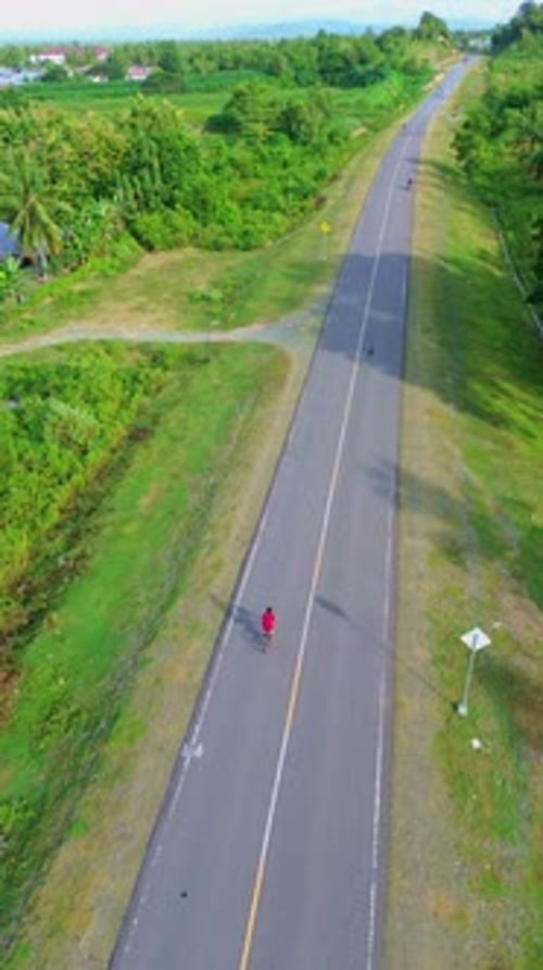 Aerial View of Cyclist on Country Road