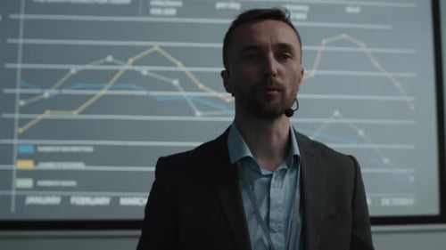 Man Delivering Corporate Presentation with Data Charts