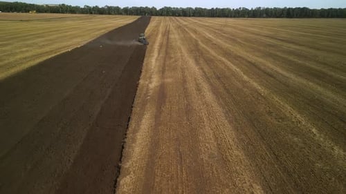 Tractors plowing the field in Ukraine