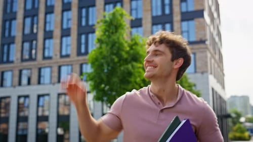 Cheerful Man Walking Street Holding Books Closeup Smiling Guy Waving Hand
