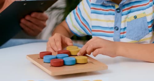 Child Playing Colorful Matching Game with Adult