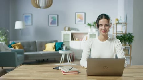 Woman Working on Laptop Computer at Home