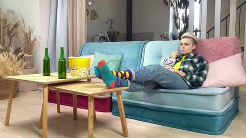 Friends Relaxing at Home With Snacks and Soccer