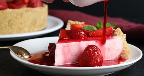 Delicious Strawberry Cheesecake Slice with Syrup Pour