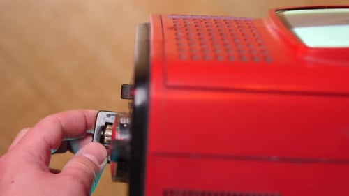 Hand Tuning Dial on Red Vintage Television