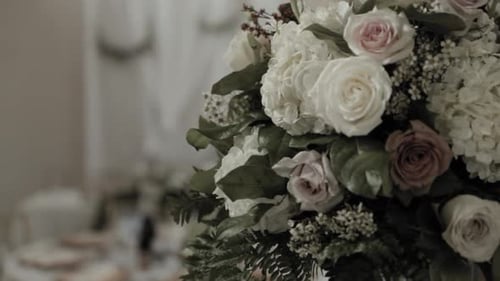 Wedding Reception Table Decorated with Flowers and Candles