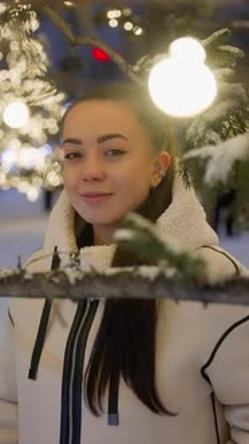 Smiling Woman Framed by Snow and Lights