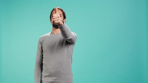Portrait of Upbeat Man Showing Thumbs Up Sign Gesturing
