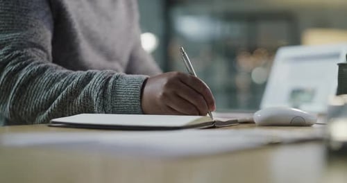 Writing in a Notebook at the Office